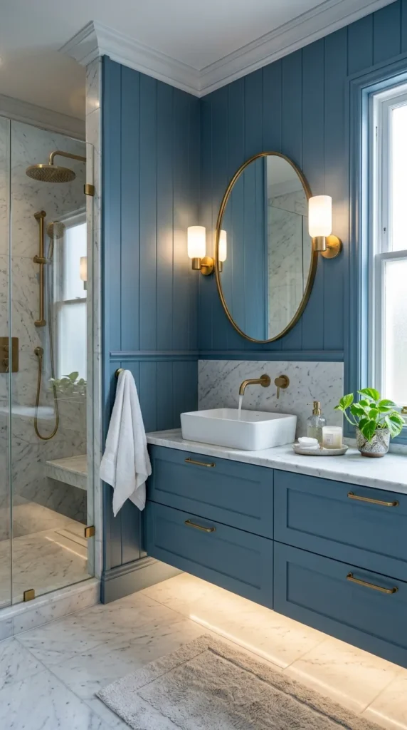 Cool blue colored bathroom with brass hardware and marble floors
